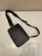 Prada black mini crossbody bag with adjustable strap and triangular logo plaque