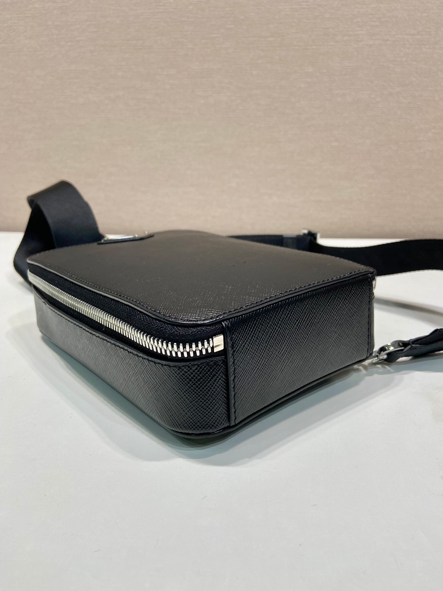 Prada black textured leather crossbody pouch bag with zipper closure