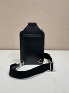 Prada black mini bag with flap top, front zipper, and crossbody strap