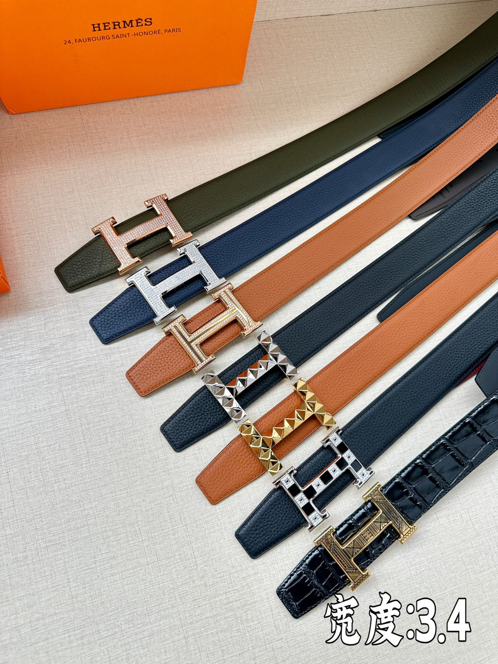 Hermes leather belt set in assorted colors with H buckles in rose-gold and silver tones.