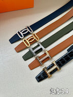Set of leather belts with metal H buckles in blue, tan, green, and navy