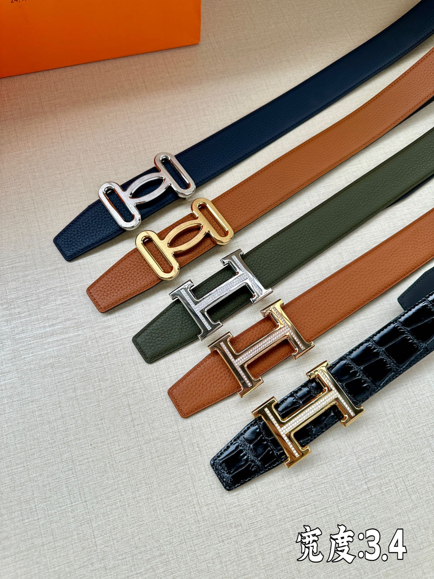 Set of leather belts with metal H buckles in blue, tan, green, and navy