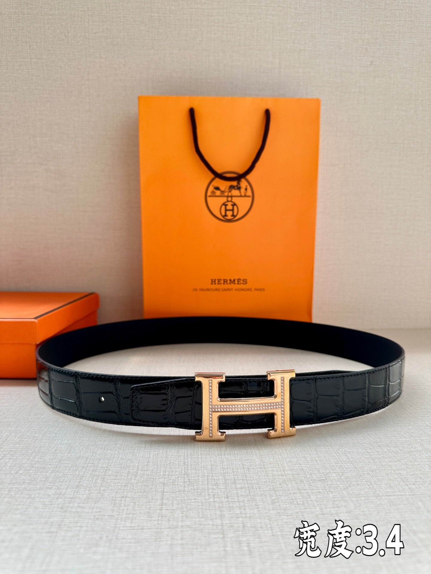 Hermes dark leather belt with embossed texture and gold-tone H buckle