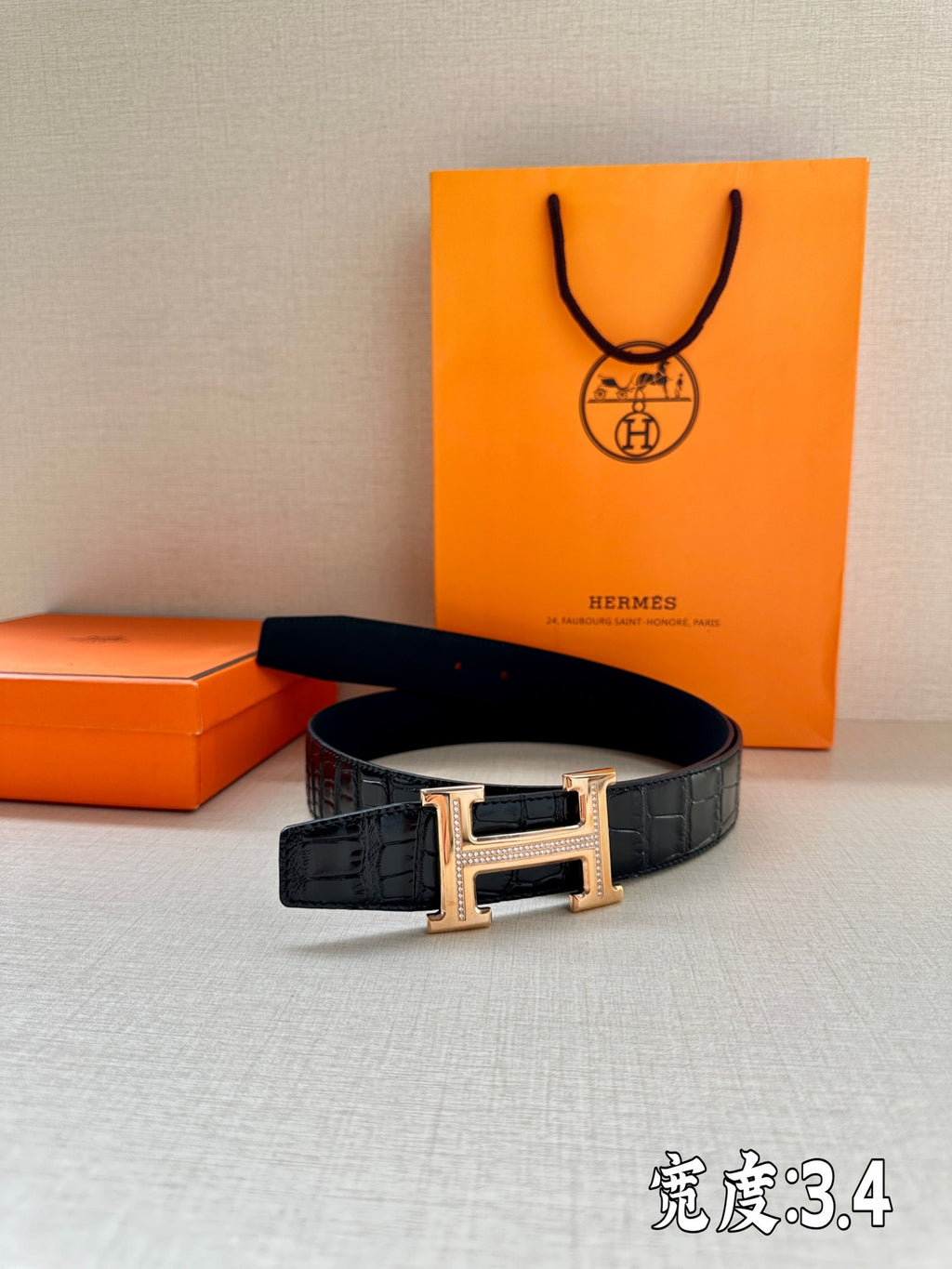 Hermes dark leather belt with embossed pattern and rectangular gold-tone buckle