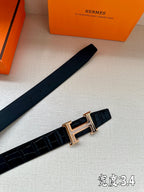 Hermes belt with dark leather strap and gold-tone buckle, laid flat