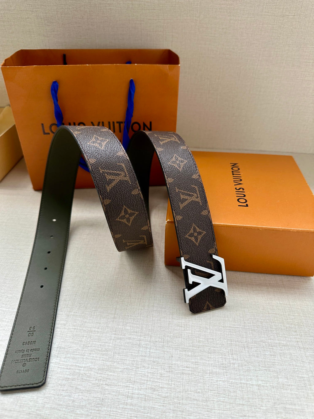 Louis Vuitton monogram belt pair with gold-tone LV buckles and olive backing straps