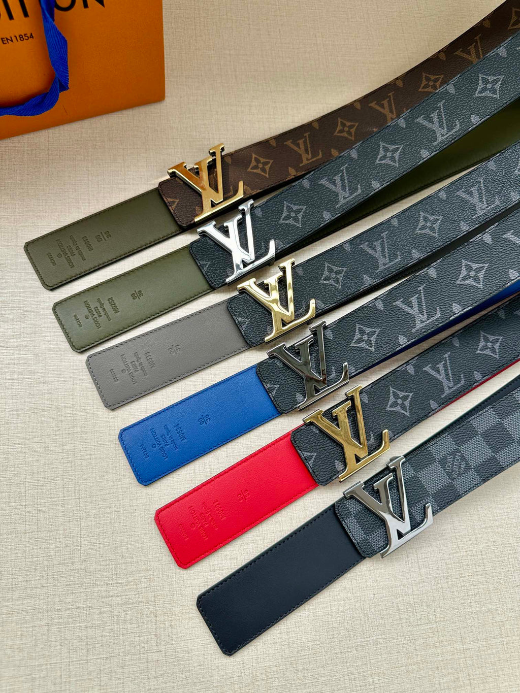 Set of Louis Vuitton LV-buckle belts with monogram straps in green, red, and navy