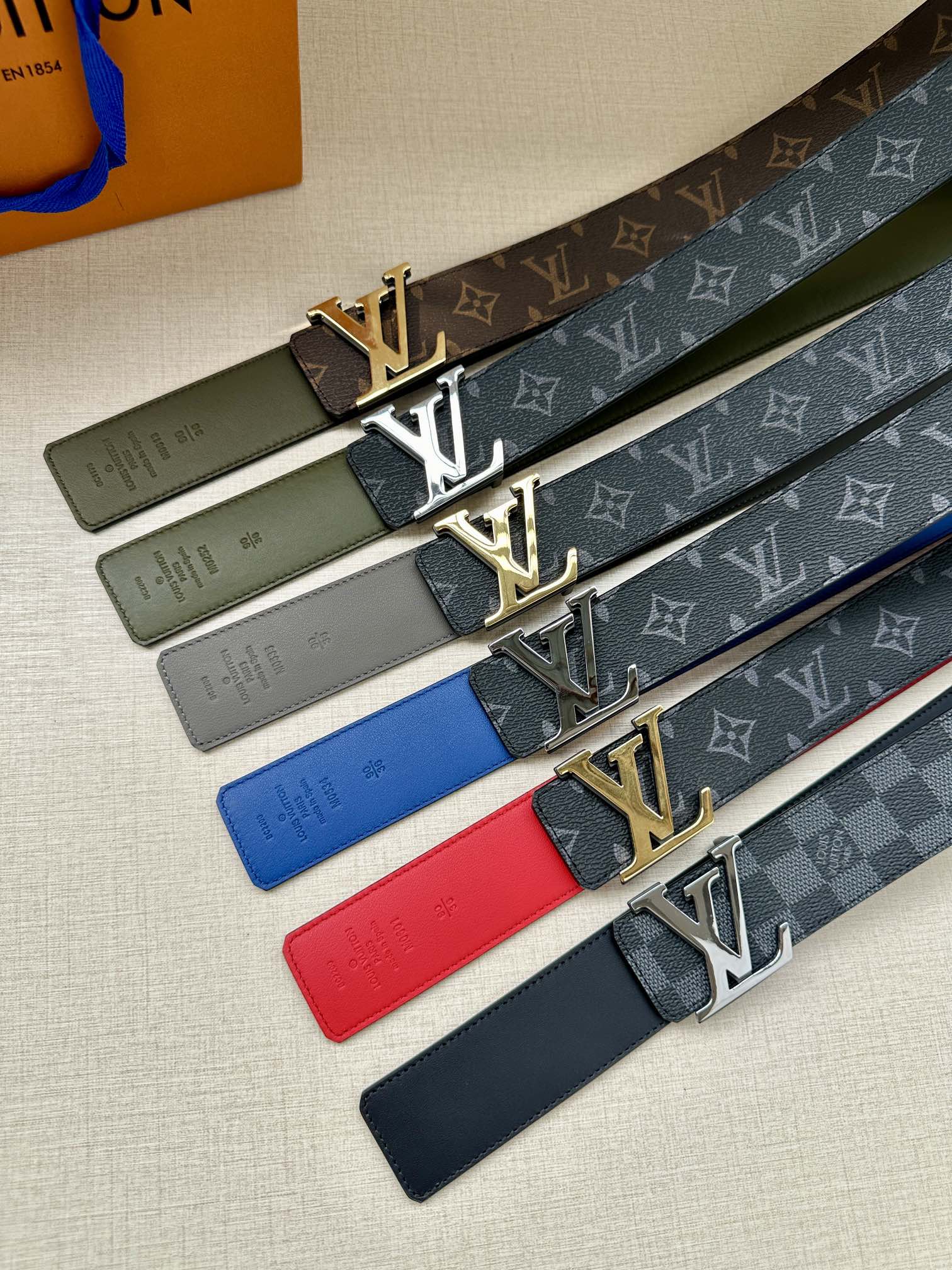 Set of Louis Vuitton LV-buckle belts with monogram straps in green, red, and navy