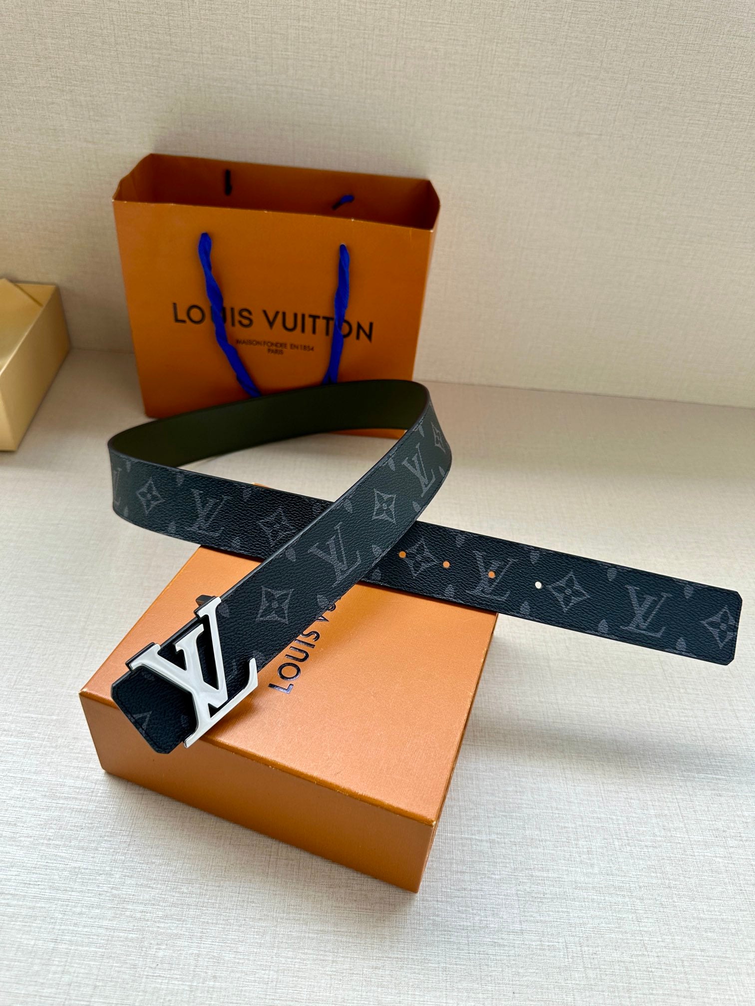 Louis Vuitton monogram belt with LV silver-tone buckle, dark blue strap and green reverse