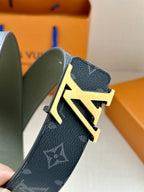 Louis Vuitton monogram belt closeup with LV gold-tone buckle on dark leather