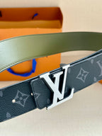 Louis Vuitton monogram belt closeup with LV silver-tone buckle on dark blue strap