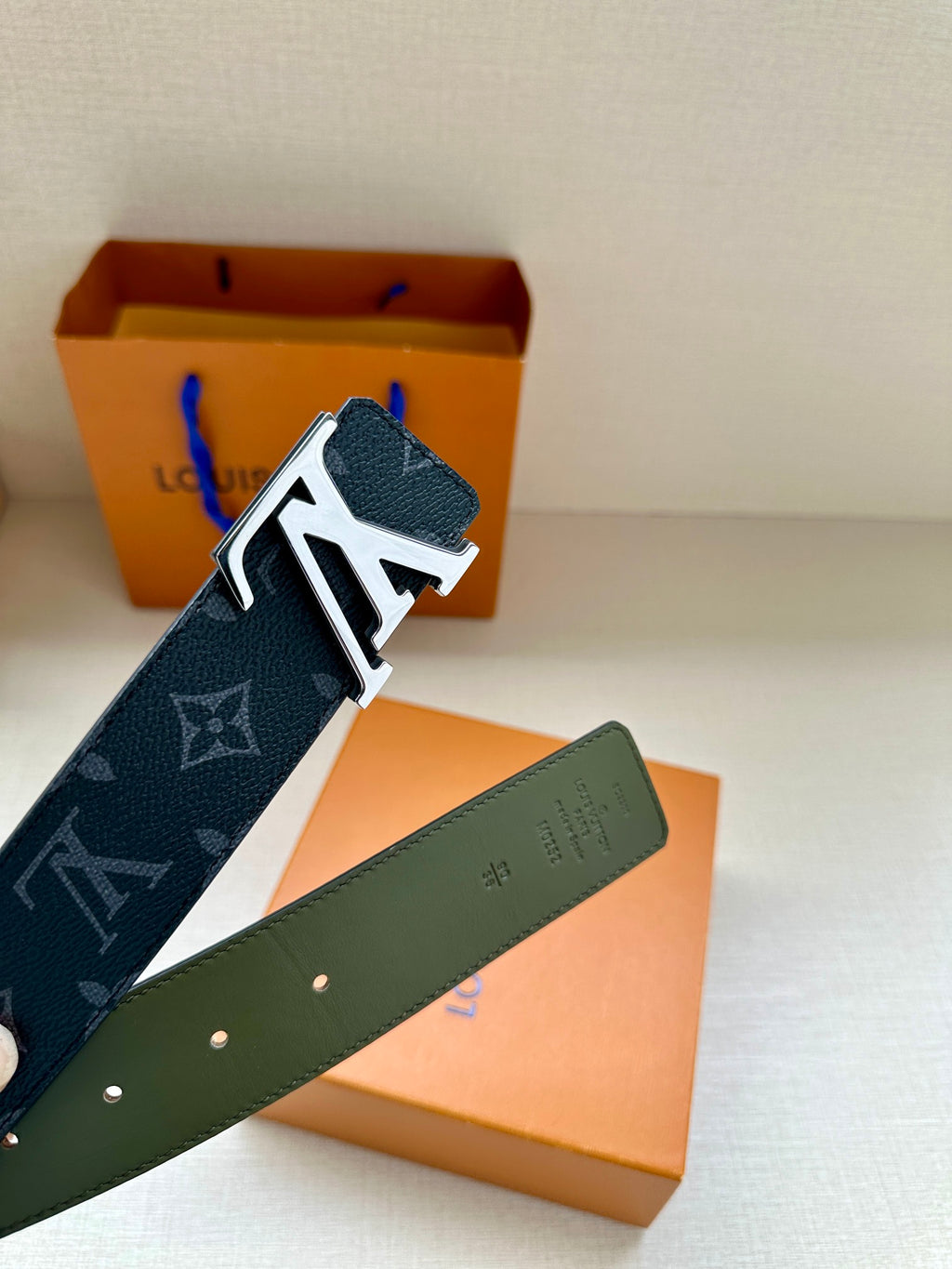 Louis Vuitton monogram belt with LV silver-tone buckle, dark blue strap and green back