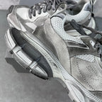 Light gray Balenciaga sneakers with high-top profile and patterned side panels
