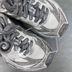 Light gray Balenciaga sneakers, close-up of laces and mesh textured upper