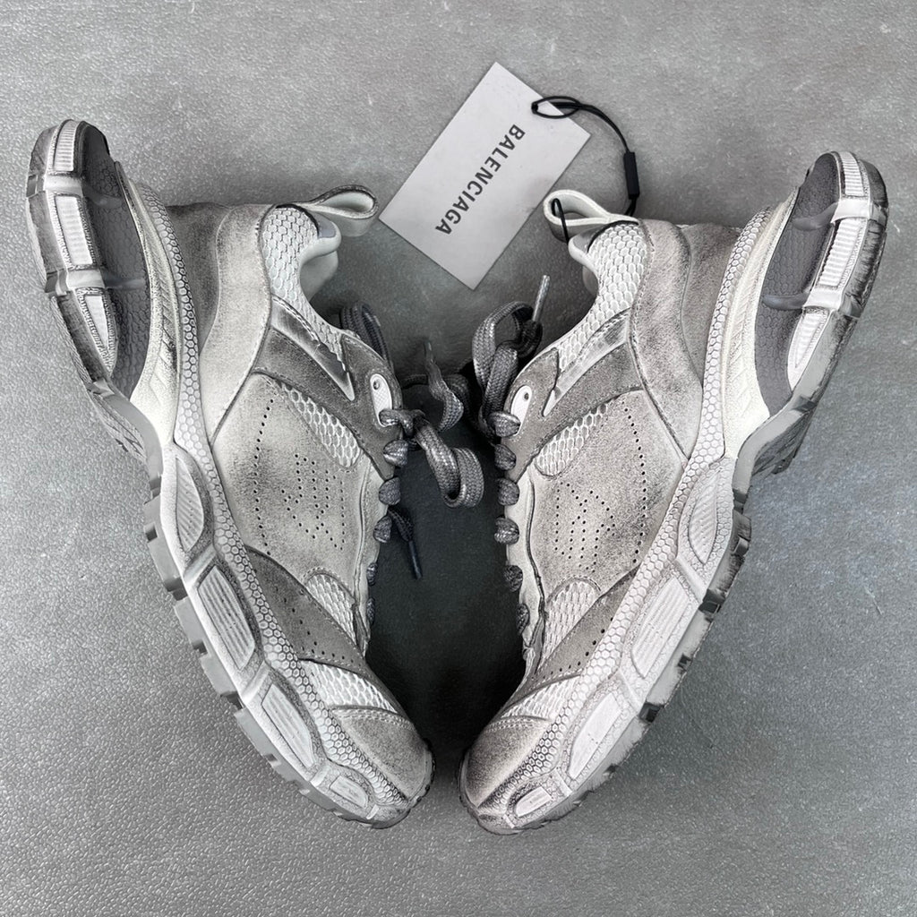Pair of light gray Balenciaga sneakers with suede and mesh panels, lace-up design