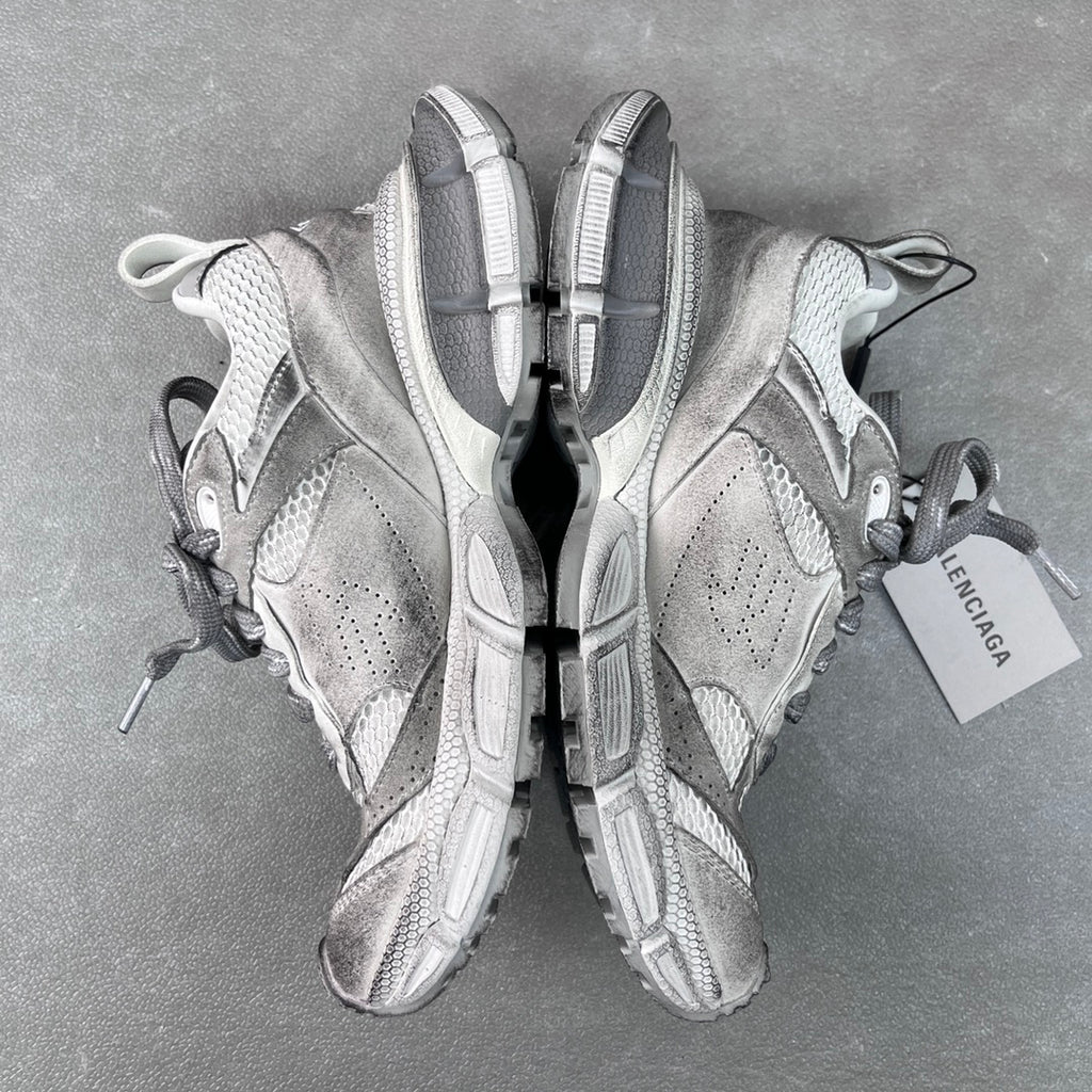 Pair of light gray Balenciaga sneakers, heel and sole view with pull tabs