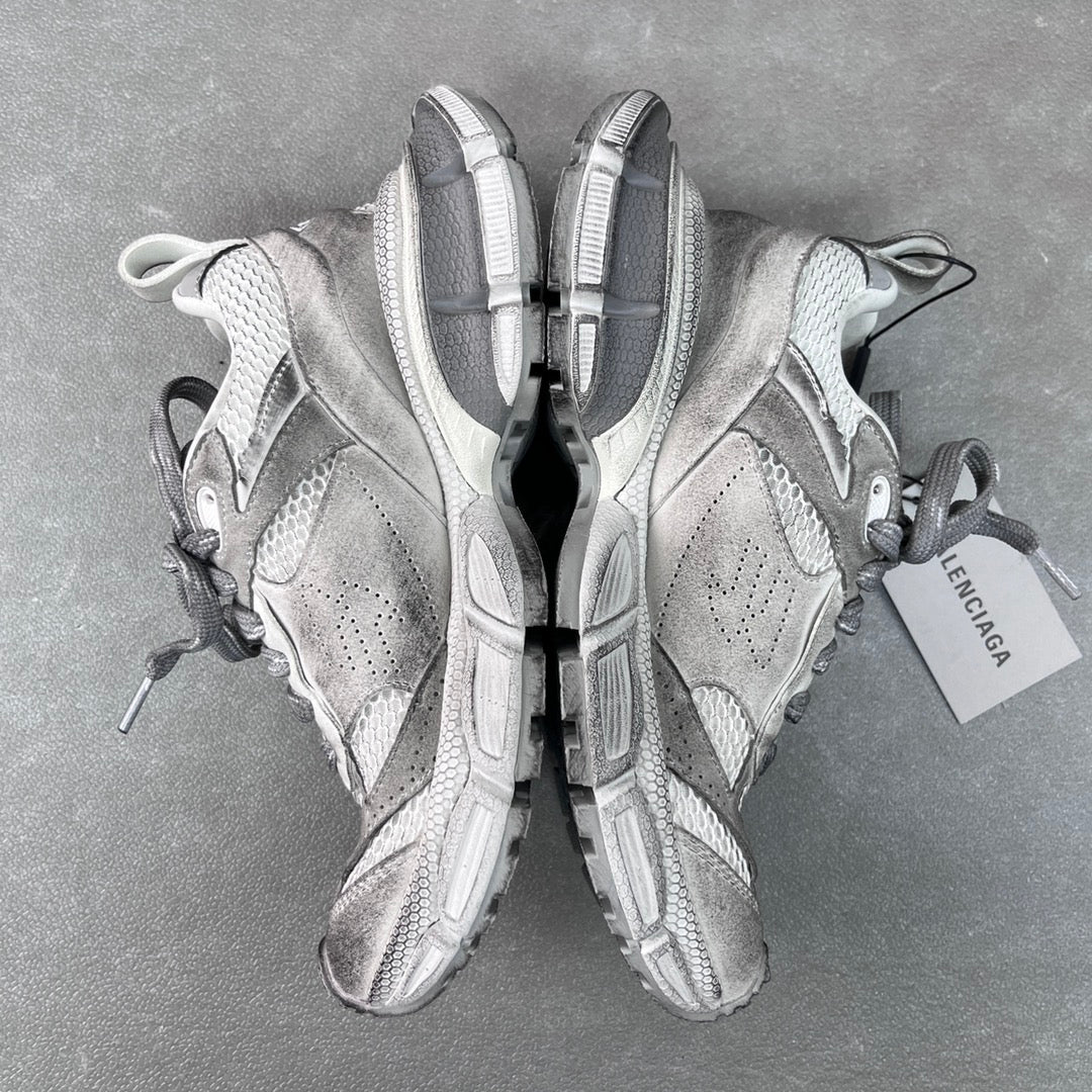 Pair of light gray Balenciaga sneakers, heel and sole view with pull tabs