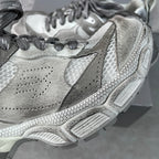 Light gray Balenciaga sneaker side view with perforations and textured panel