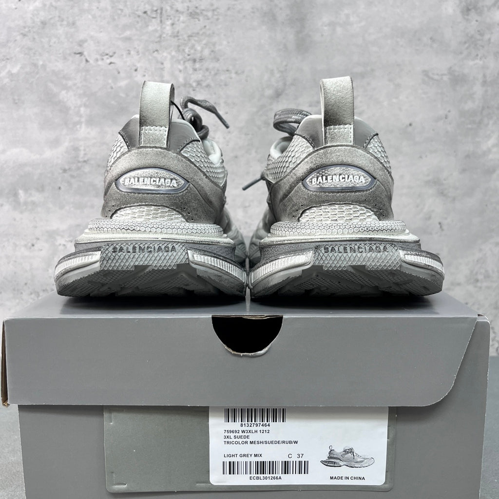 Light gray Balenciaga sneakers with heel branding on the box