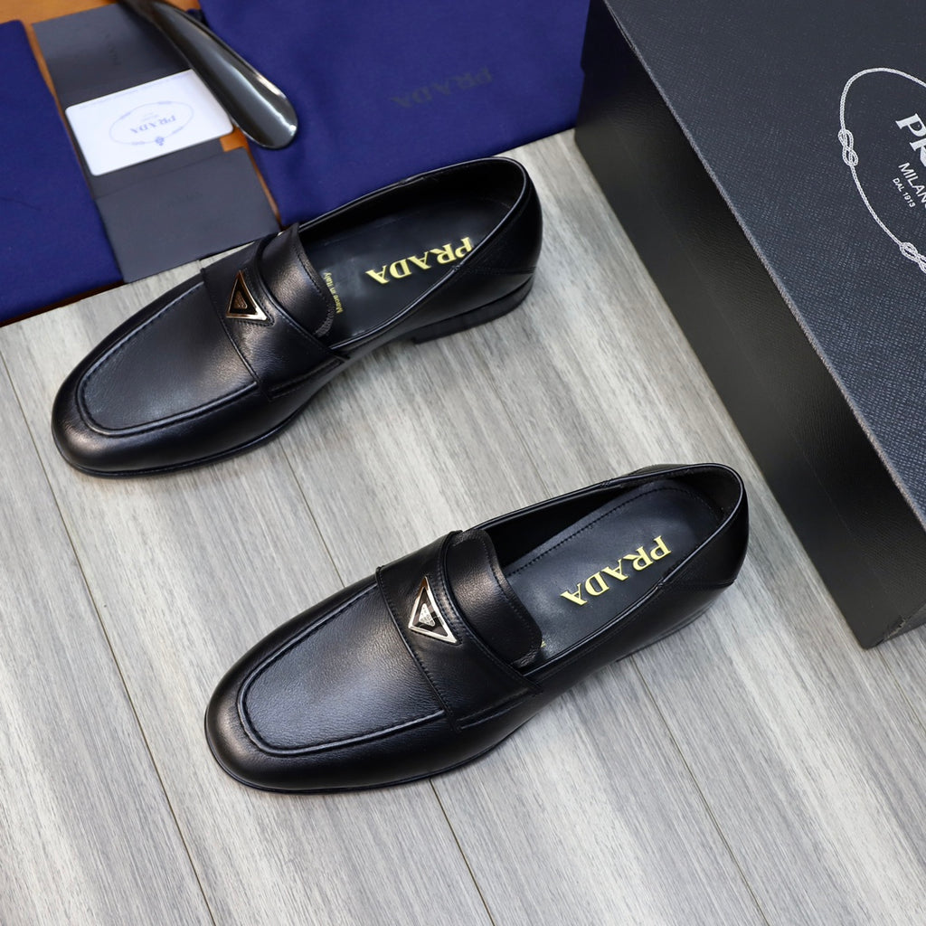 Black leather loafers with Prada triangle emblem and Prada on insole