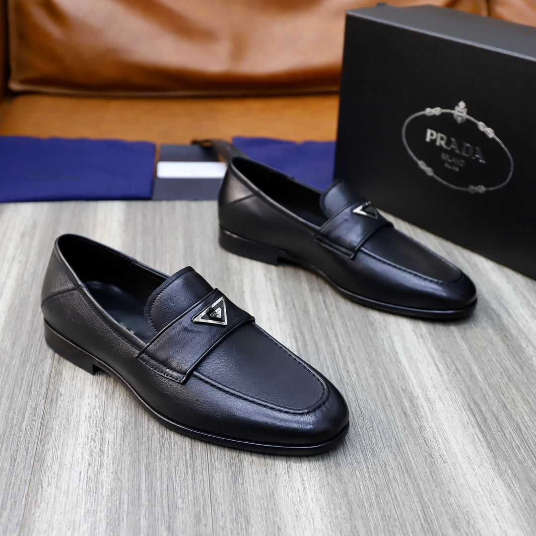 Black leather loafers with Prada triangle logo on upper, side-by-side