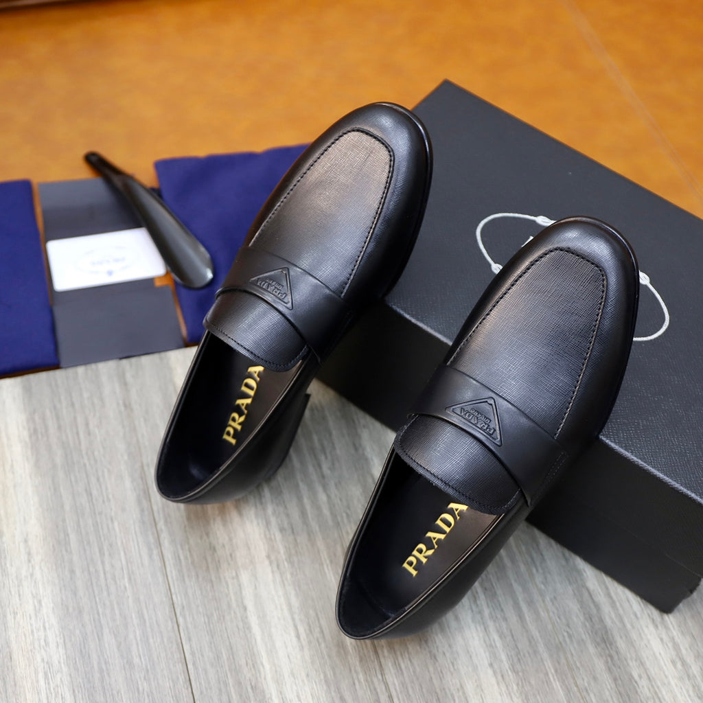 Prada unisex black leather loafers with strap, visible Prada logo on inner lining
