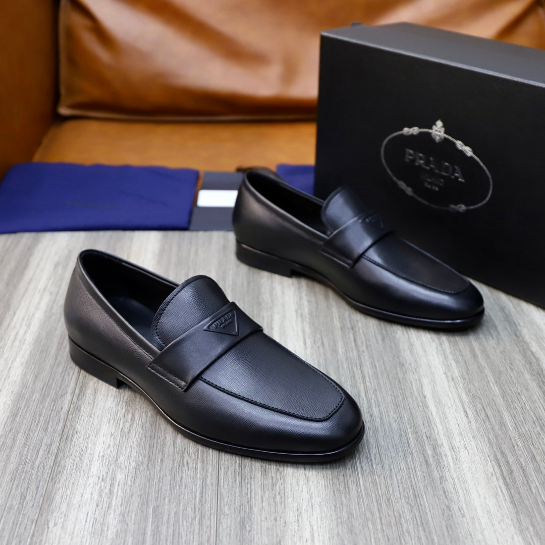 Prada unisex black leather loafers, slip-on design with strap detail, angled pair