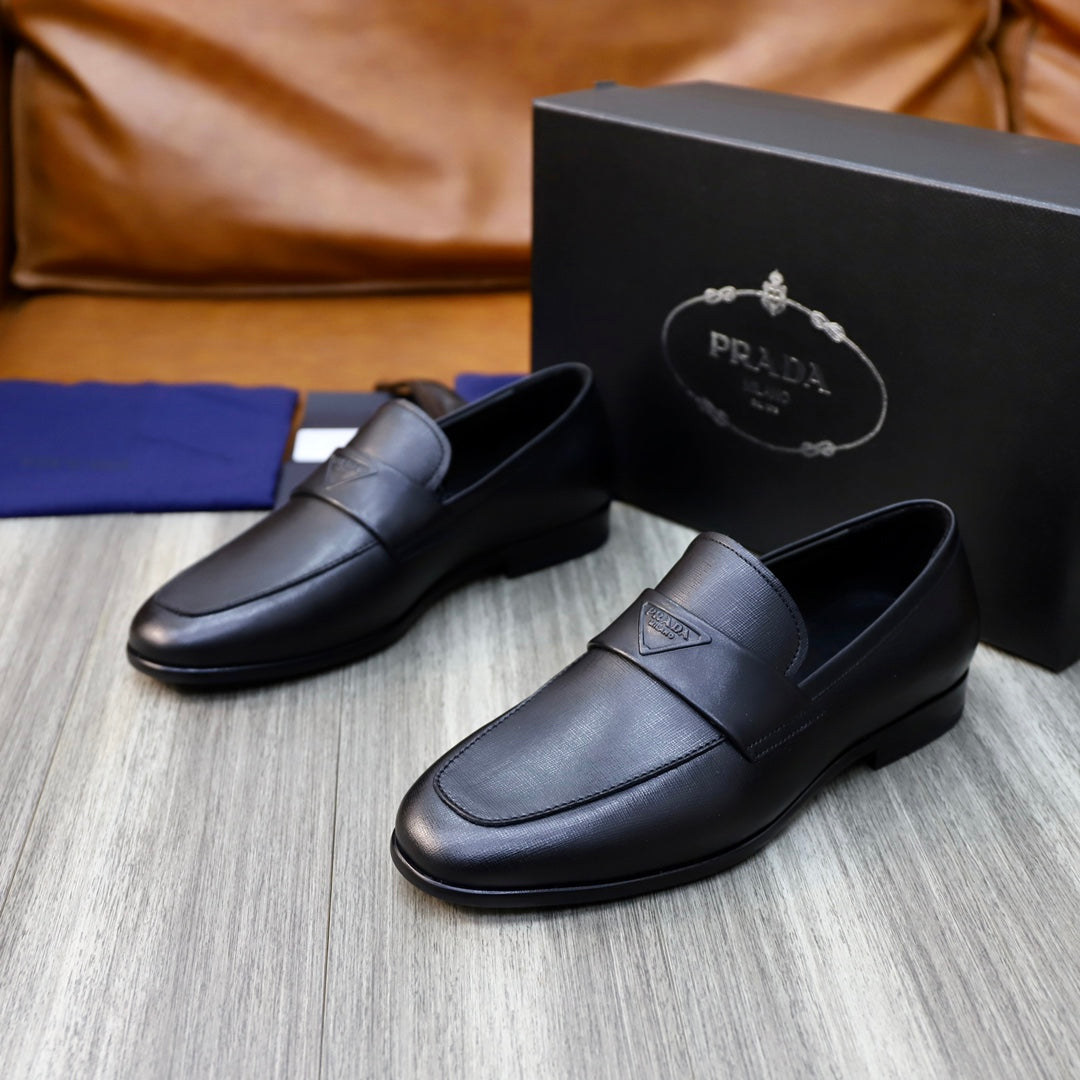 Unisex black leather loafers with strap detail and embossed logo, side-front view