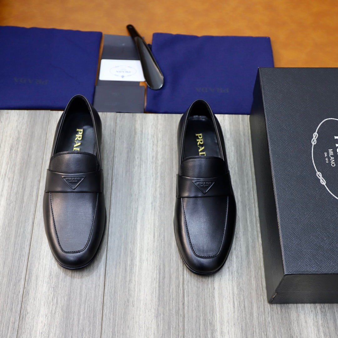 Prada unisex black leather loafers with strap and logo badge, pair front view