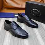Prada black leather lace-up shoes with dark box nearby