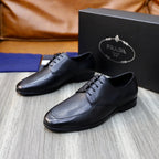 Prada black leather lace-up shoes, angled view on display box