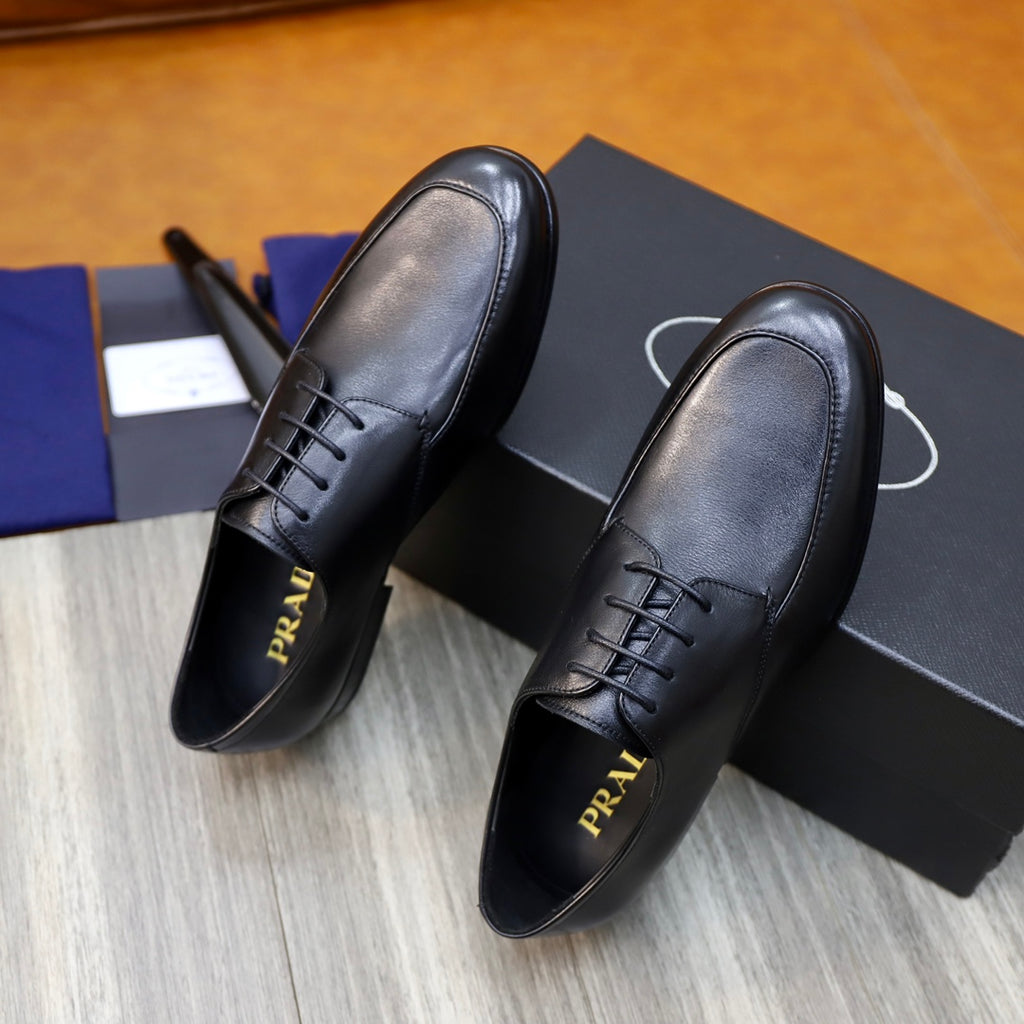 Prada black leather lace-up shoes with logo on insides, close-up pair