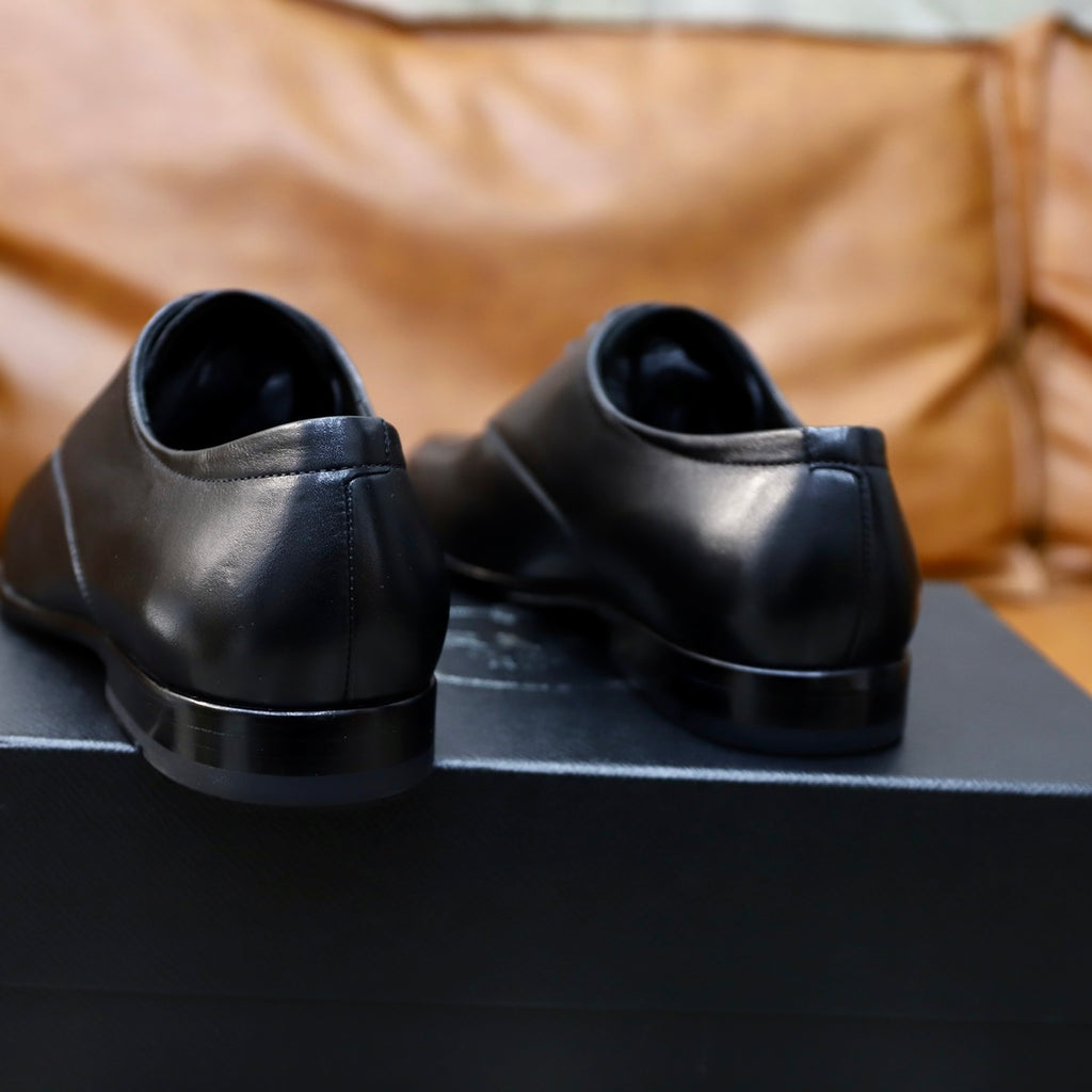 Prada black leather lace-up shoes, back view showing low heel