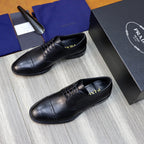 Black leather lace-up shoes with textured panels and brogue holes, Prada