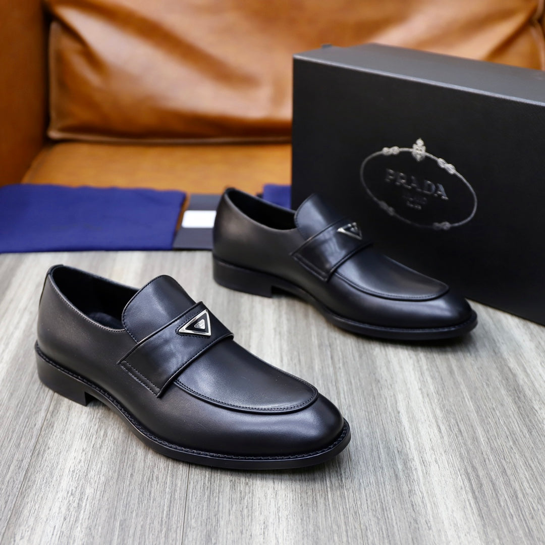 Prada unisex black leather loafers with wide strap and metal-triangle logo on toe