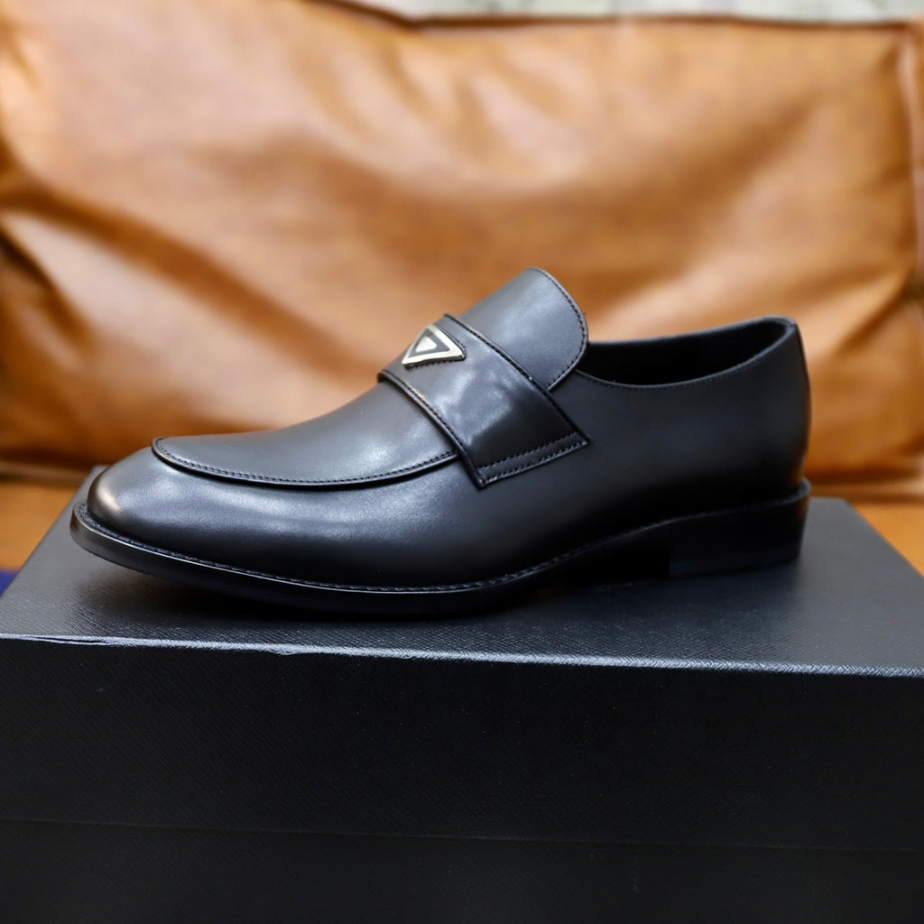 Prada unisex black leather loafer, close side profile with metal-triangle logo
