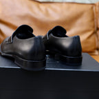 Prada unisex black leather loafer, heel and back view with low block heel