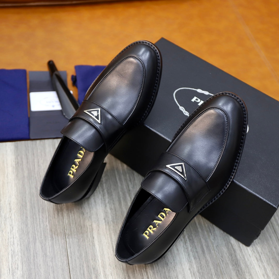 Prada unisex black leather loafers, side view showing padded strap and insole branding