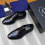 Black leather lace-up oxfords showing tongue detail and low heel sole