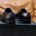 Black leather lace-up oxford shoes, back view with heel profile