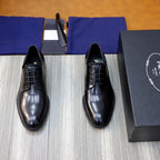 Prada unisex lace-up oxfords in dark shiny leather, rounded toe, black laces.