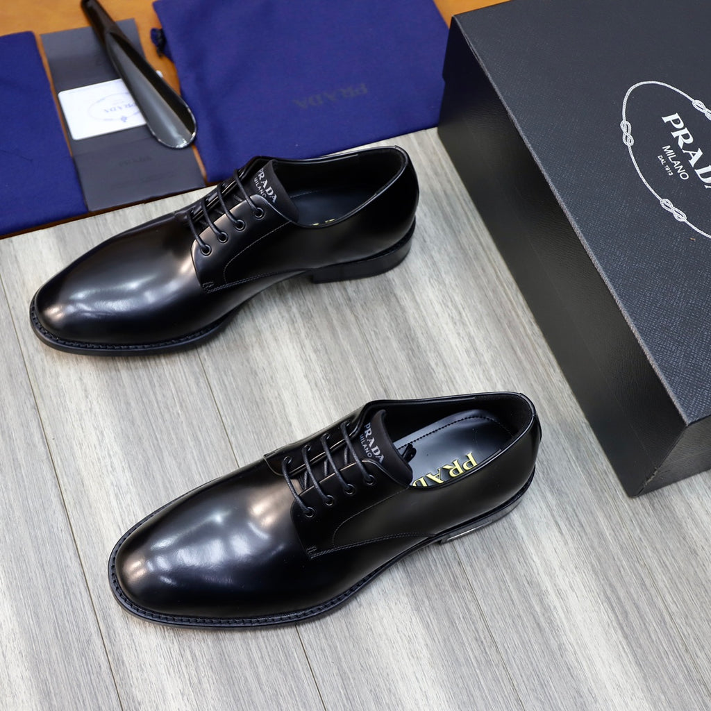 Prada unisex lace-up oxfords in dark leather, side-by-side on light wood floor.