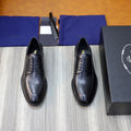 Prada black leather lace-up oxford shoes with rounded toe, front view on a pair