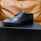 Prada black leather lace-up oxford shoe, single front profile on display box