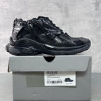 Balenciaga unisex chunky sneaker on box, black mesh and glossy panel uppers.