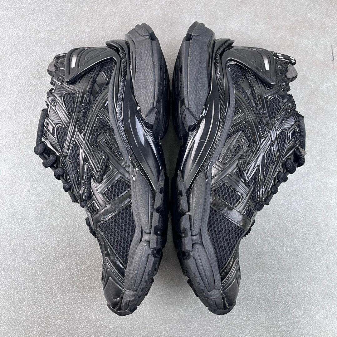 Balenciaga unisex sneakers rear side view, black with metallic panel accents.