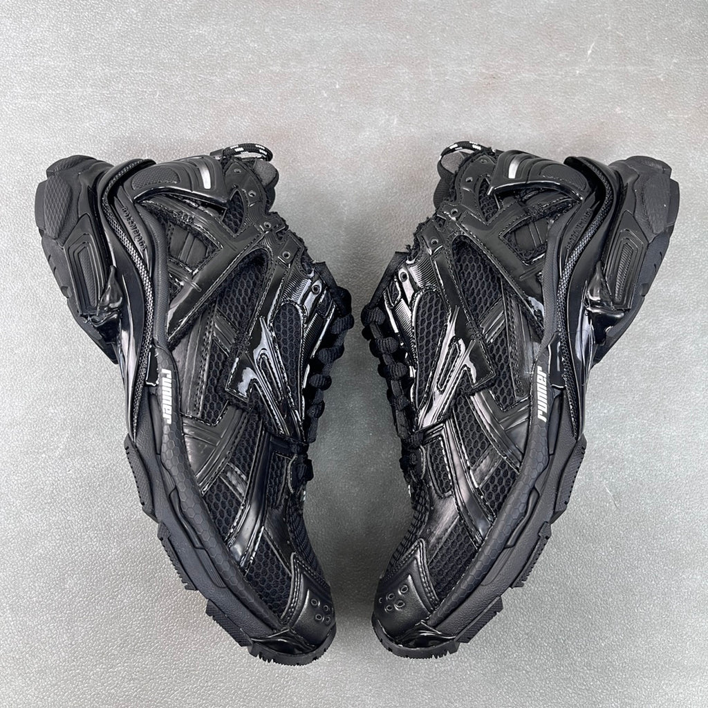 Balenciaga unisex chunky sneakers, black with metallic panels and lace-up design.