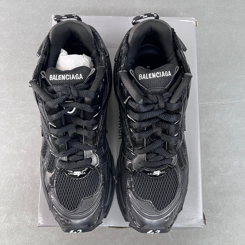 Balenciaga unisex sneakers front view, black uppers with BALENCIAGA tongue branding.