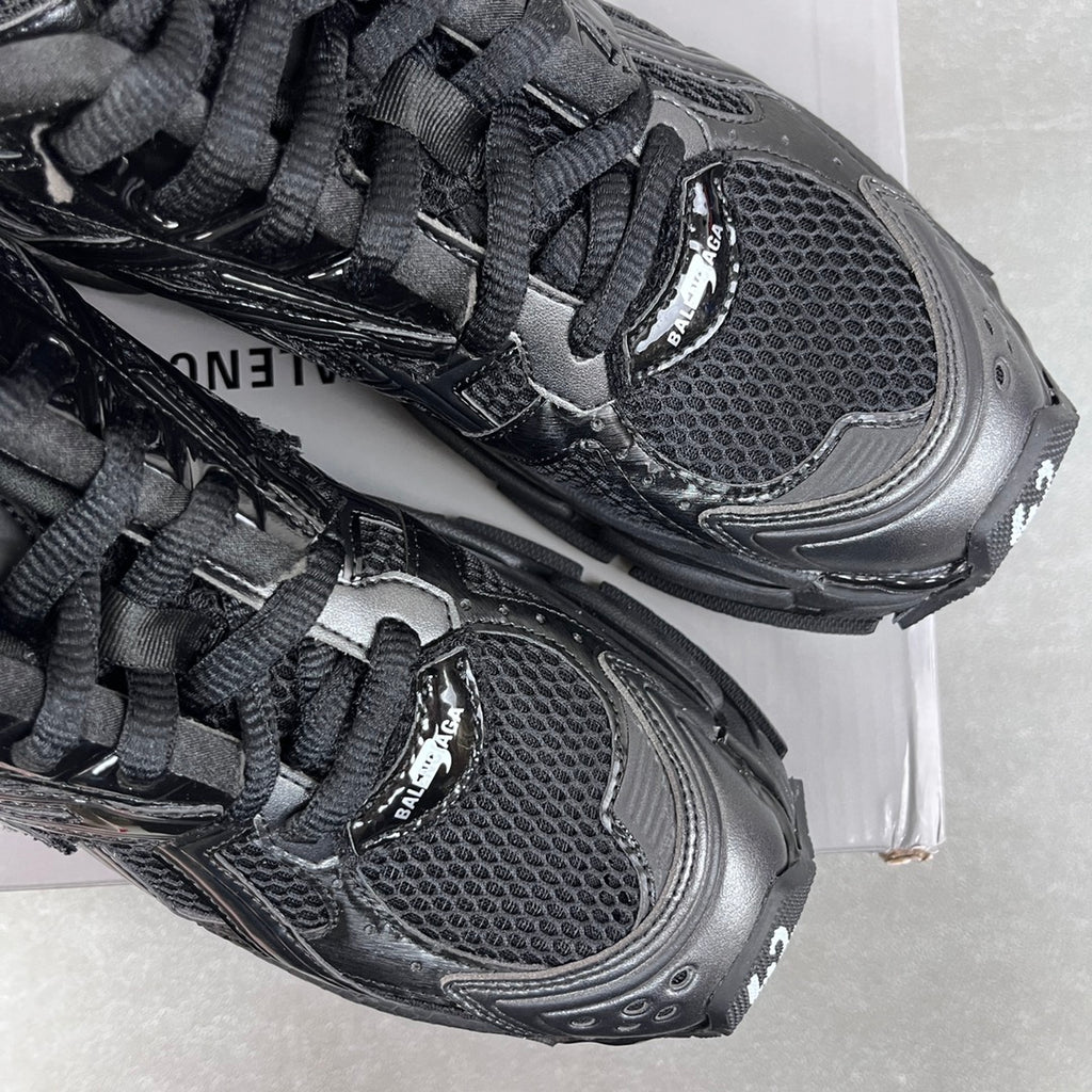 Balenciaga unisex sneaker toe and lace detail, black mesh upper and rubber trim.