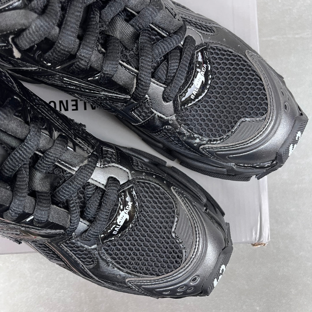 Balenciaga unisex sneaker toe and lace detail, black mesh upper and rubber trim.